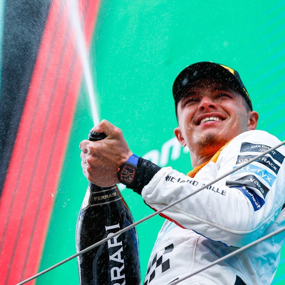 Lando Norris celebrating on the podium at Silverstone