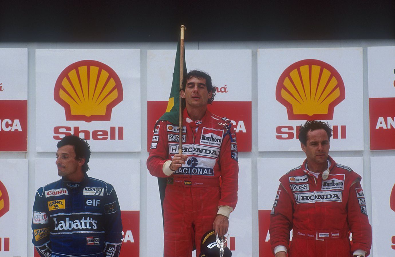 Ayrton Senna celebrates with the Brazilian flag after winning his first Brazilian Grand Prix in 1991