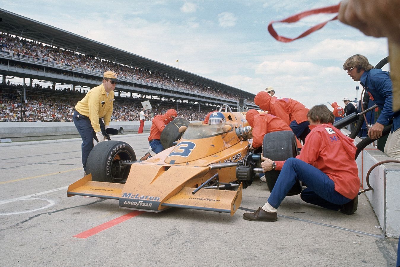 Johnny Rutherford stops for tyres and fuel on his way to victory in 1974